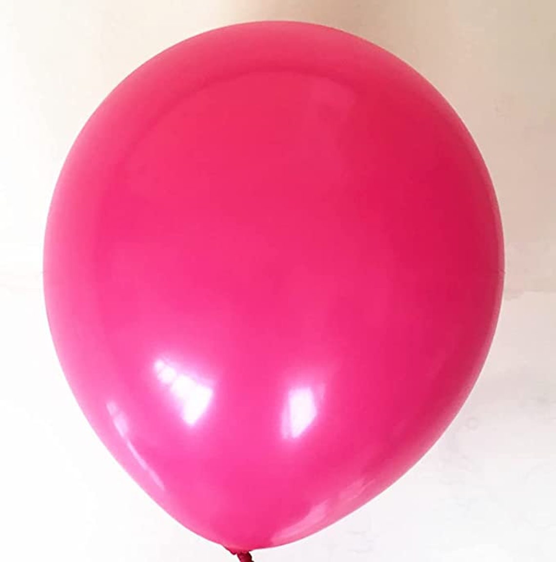 Vibrant Hot Pink and Black Balloon Array - Chic and Daring Atmosphere for Lively Festivities!